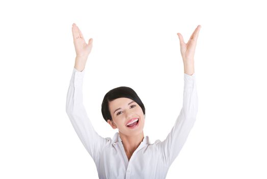 Young happy businesswoman with hands up, isolated on white