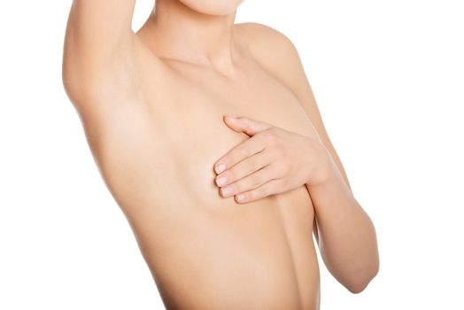 Torso of beautiful slim topless woman covering her breast with hand. Breast cancer and braest care concept
