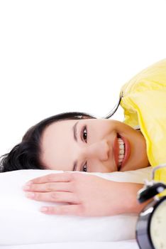 Happy sensual young woman lying in bed and smiling to camera