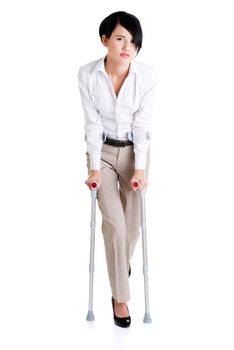 Young businesswoman with crutches, isolated on white. Disabled person in work.