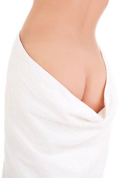 Rear view of slim tanned woman's body in towel.