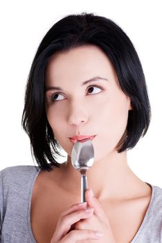 Portrait of young smiling woman with spoon in her mouth (pleasure from eating), isolated on white