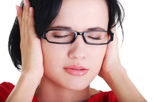 Closeup of frustrated young woman holding her ears, isolated on white