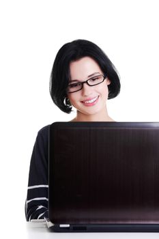 Happy young woman using her laptop, isolated on white.