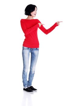 Happy , excited young woman pointing on copy space, isolated on white