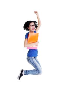 Happy female student jumping with a notebook isolated