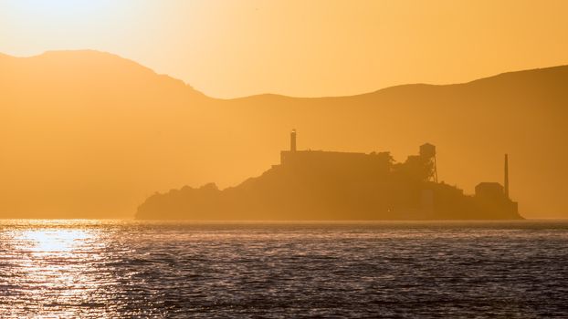 Alcatraz island penitentiary at sunset backlight in san Francisco California USA