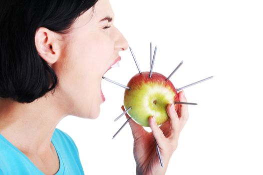 Throat pain concept. Woman eating apple with nails.