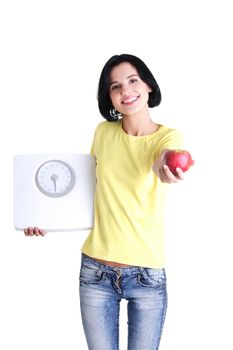 Beautiful young woman holding scales and apple