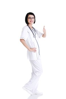 Full portrait of young female doctor or nurse gesturing OK