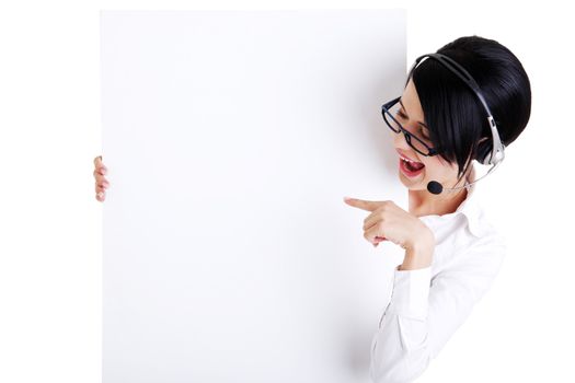 Pretty young call center worker wearing a headset and holding blank sign board