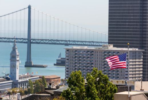 San Francisco USA American Flag Bay Bridge and Embarcadero Clock Tower from Telegraph Hill