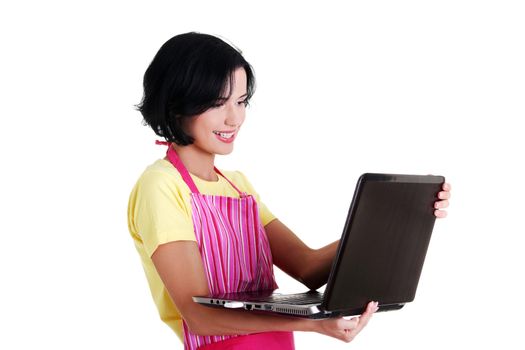 Modern housewife or female worker with laptop wearing pink apron