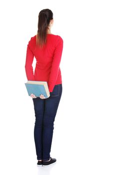 Back view of young student woman holding an old book. Isolated over white background.