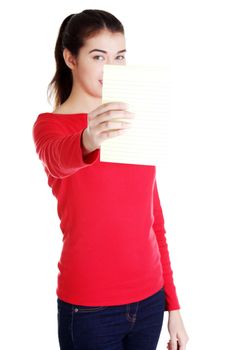 Young happy student woman showing blank notepad, isolated on white background