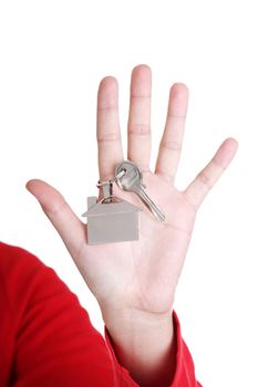 Hand holding a house key. Isolated on white background.