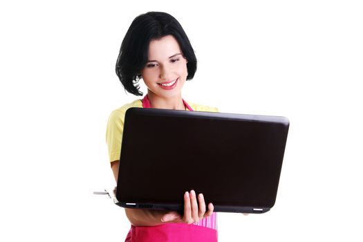 Modern housewife or female worker with laptop wearing pink apron