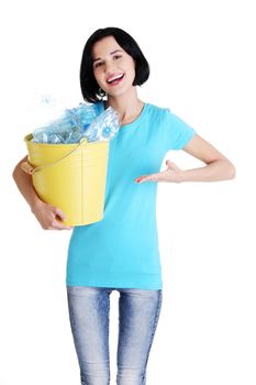 Beautiful young woman holding recycling bin isolated on white background.