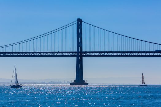 San Francisco Bay bridge sailboat from Pier 7 in California USA