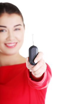 Happy woman with a car key. Isolated on white
