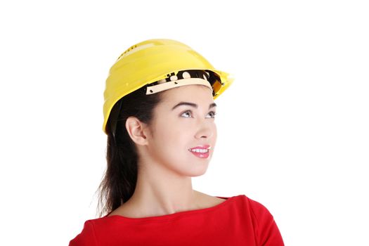 Portrait of confident female worker in helmet looking up. Isolated on white