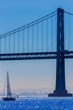 San Francisco Bay bridge sailboat from Pier 7 in California USA