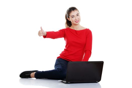 Happy young woman using her laptop, isolated on white.