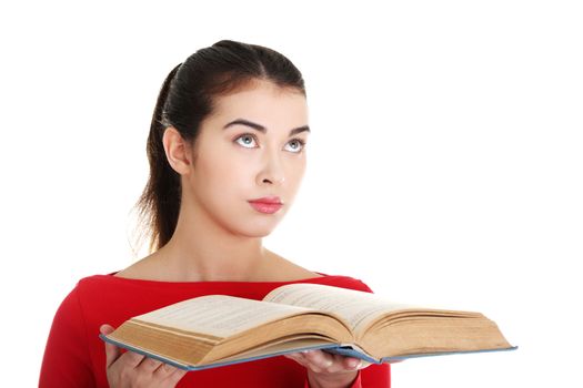 Young woman reading an old book, isolated on white