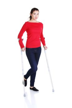 Woman walking with crutches becouse of leg injury