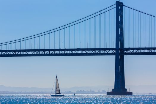 San Francisco Bay bridge sailboat from Pier 7 in California USA