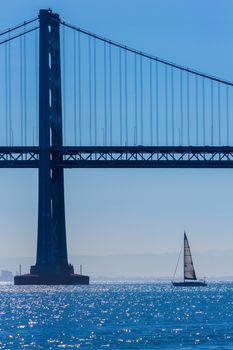 San Francisco Bay bridge sailboat from Pier 7 in California USA