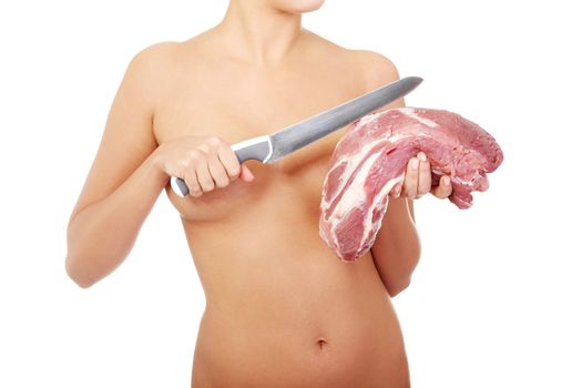 Nude woman holding big part of raw meat (pork neck) and knife. Protein diet concept.