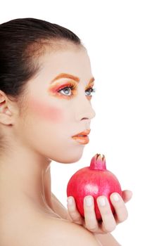 Portrait of young beautiful woman with pomegranates in her hands, on white background