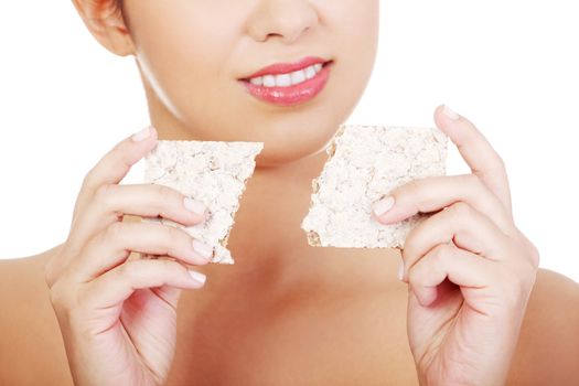 Young pretty woman eating healthy rye cracker bread