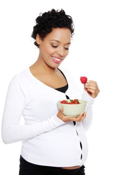 Portrait of a beautifyl young woman eating strawberries, isolated on a white background.