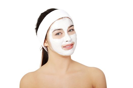 Beautiful woman with clay facial mask, isolated on white