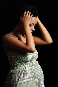 Depression and stress of young pregnant woman against black background