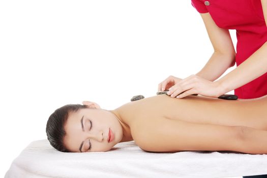 Beauty woman relaxing in spa. Stone massage.