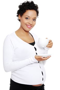 Young pretty pregnant woman drinks cafe or tea