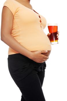 Pregnant woman holding a glass of alcohol next to her tummy, isolated on white background.