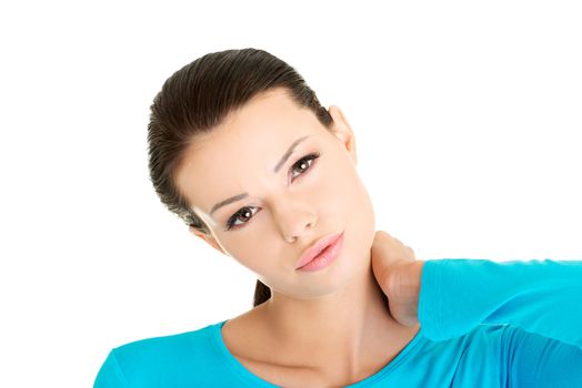 Young woman holding hand on her neck. Neck pain concept