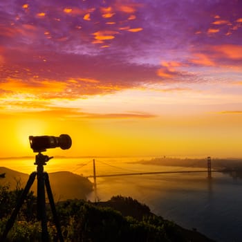 Golden Gate Bridge San Francisco sunrise California USA with photo camera silhouette