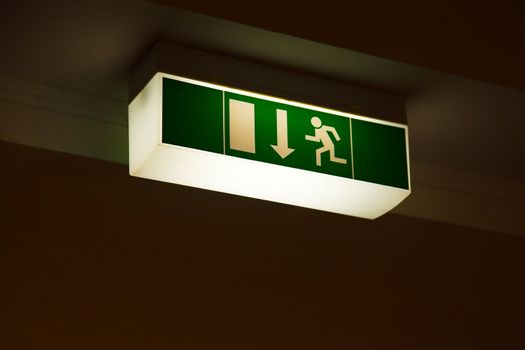 Emergency exit sign glowing in the dark