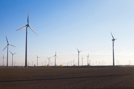 Many wind power turbines on a field