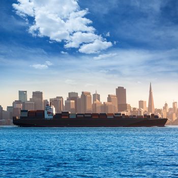 San Francisco Skyline with merchant ship cruising bay at California USA
