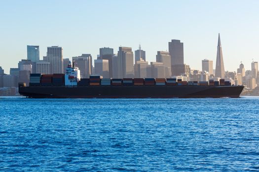 San Francisco Skyline with merchant ship cruising bay at California USA