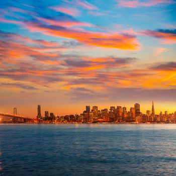 San Francisco sunset skyline in California with reflection in bay water USA