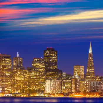 San Francisco sunset skyline in California with reflection in bay water USA