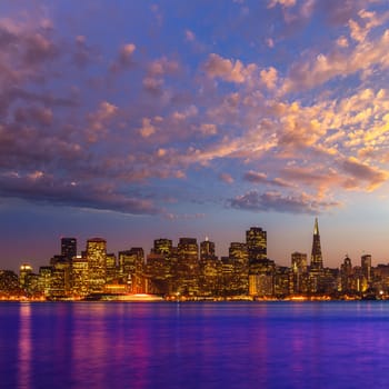 San Francisco sunset skyline in California with reflection in bay water USA