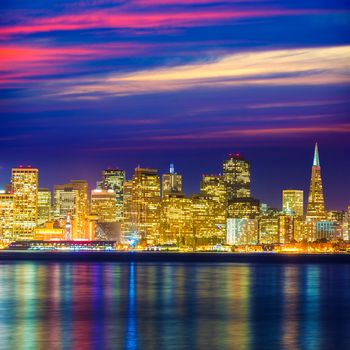 San Francisco sunset skyline in California with reflection in bay water USA